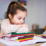 Tired And Bored Student With Stack Of Books